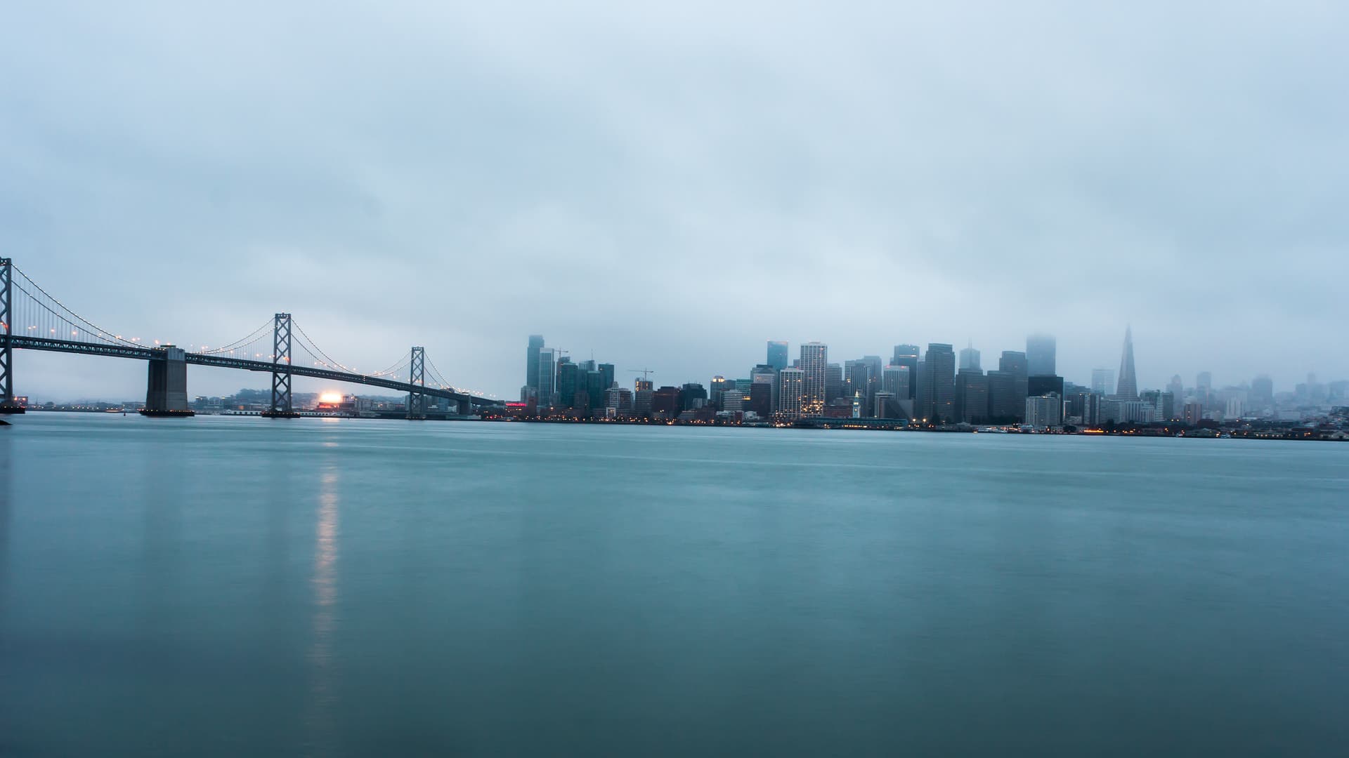 The Bay Bridge and San Francisco skyline across the bay.